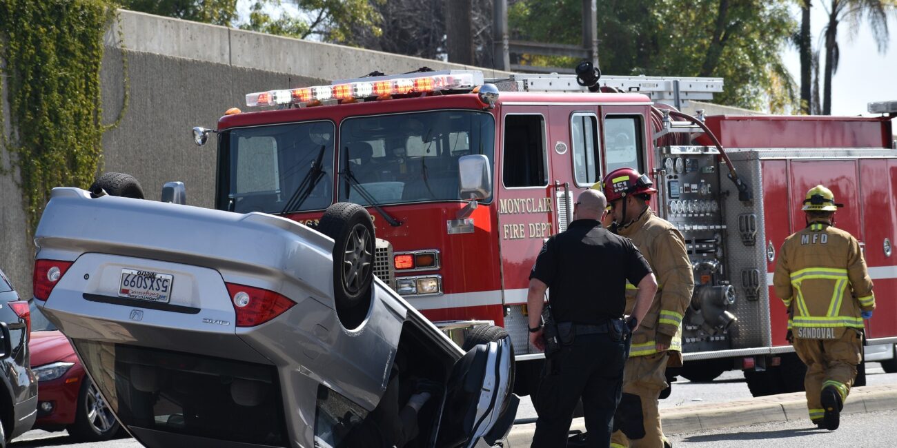 overturned car with firetruck nearby