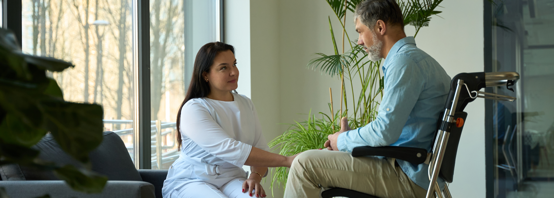 physical therapist with patient in wheelchair