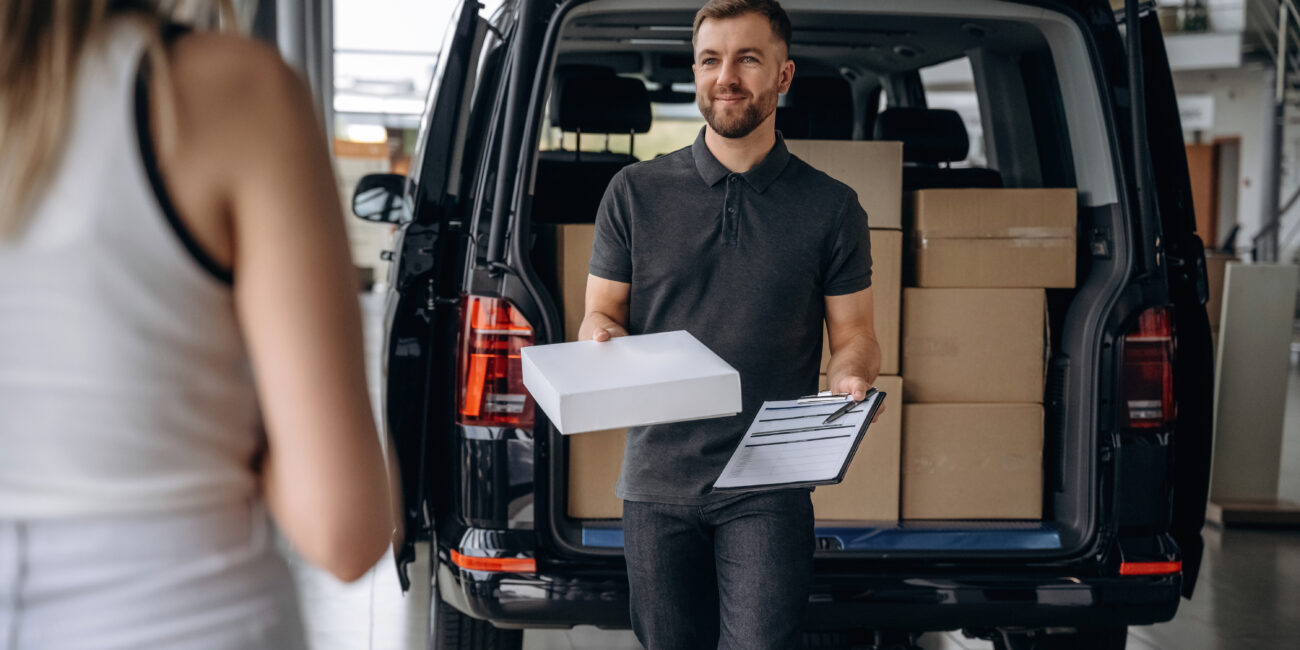 Woman with delivery man and delivery truck